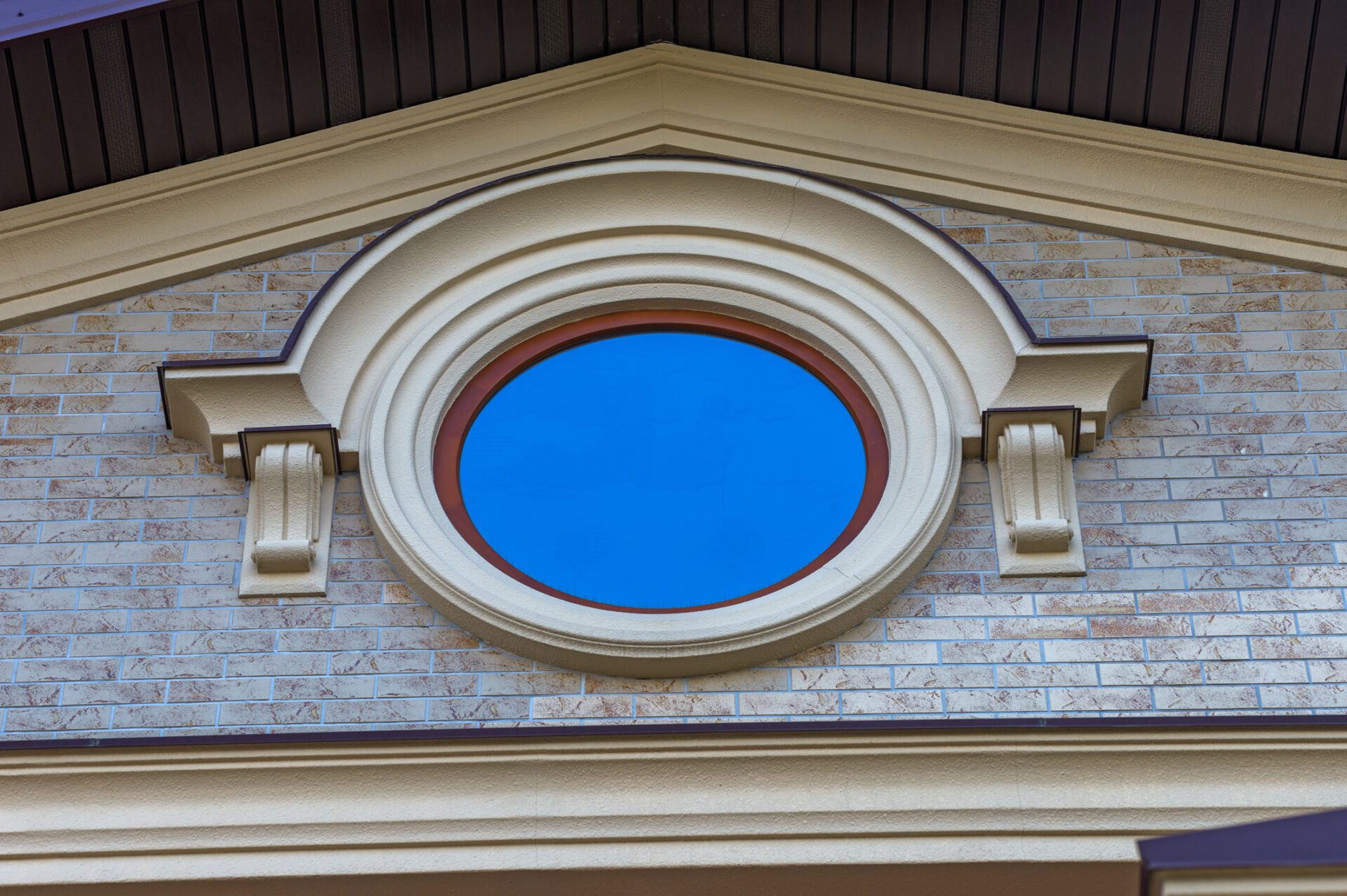 Round window in the attic of the house Specialty Windows